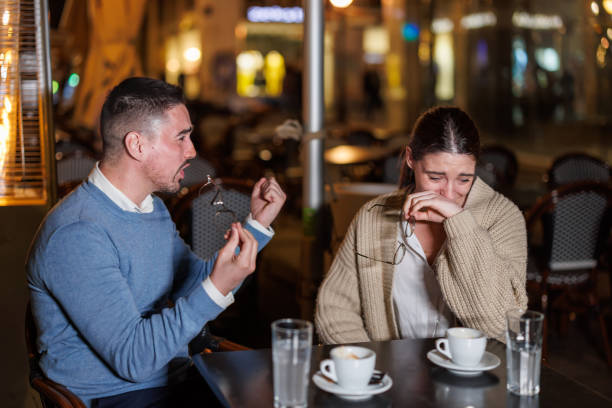 istock Couple in a Heated Dispute Exchanging Strong Views in a Cafe 1842165529