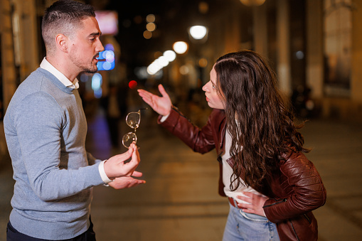 Experience the raw emotions as a boyfriend and girlfriend engage in a heated nighttime street dispute