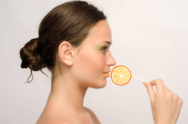 istock Beautiful woman posing with a sweet lollipop, colored candy 184218902