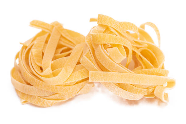 istock Two Classic Italian Raw Egg Fettuccine - Isolated on White Background 1842199361