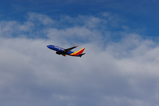 Denver, CO USA - December 4, 2023: Airplane taking off from Denver International Airport on a partly cloudy winter day. Southwest Airlines