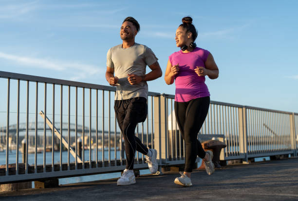 istock friends jogging together in marina 1842243016