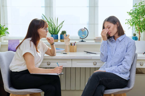 istock Sad stressed young woman in therapy with psychologist 1842244059