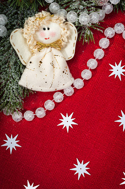 istock christmas decoration and angel toy on red textile 184224924
