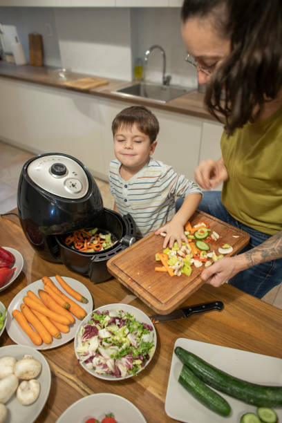 istock Happy little boy having fun while making veggie meal with mom 1842261960