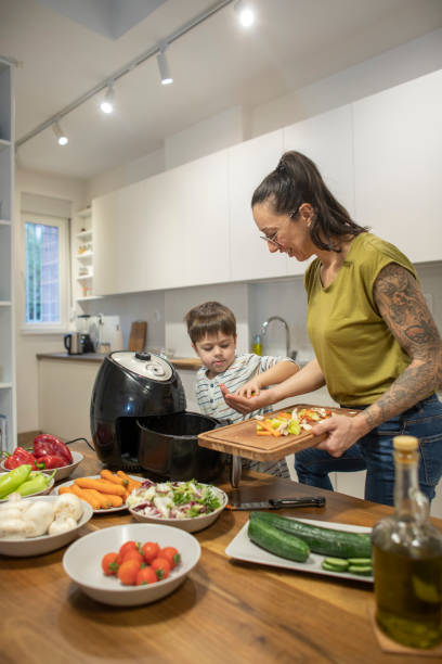 istock Little boy helping his mom with cooking 1842261970