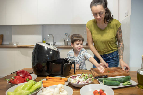 istock Boy and his mom preparing veggies 1842261975