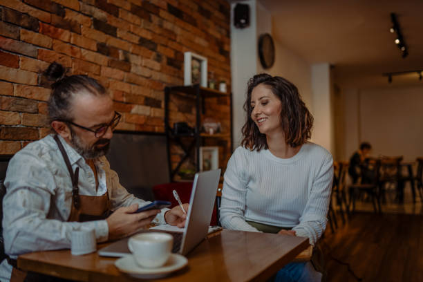 istock Coffee shop owner preparing the store for customers 1842273404