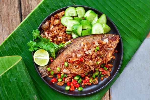istock fried fish,Garlic fried fish,pikled fish, top view food table, With side vegetables  dishes, thai call pla som tod 1842277087