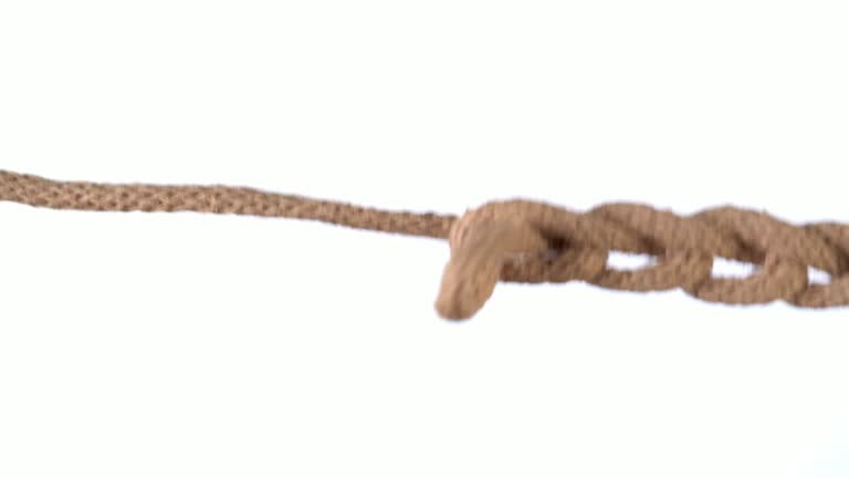 Untangling uncoupling knitted loops close up slow motion.
