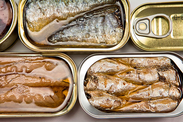 istock Small open tin cans of fish in oil 184228426
