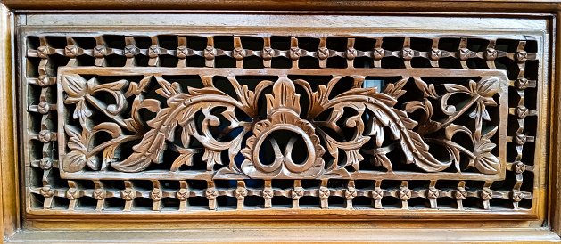 texture of varnished wood carvings on wooden house posts