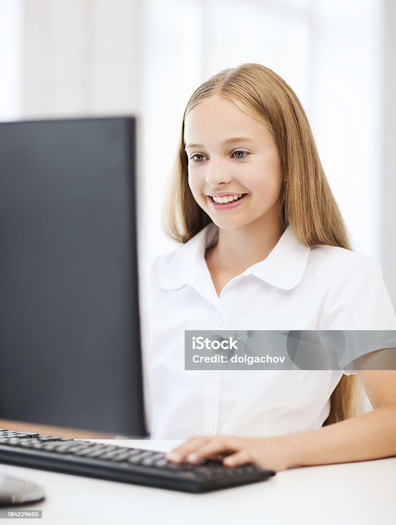 student girl with computer at school education, school, technology and internet concept - little student girl with computer at school Adult Student Stock Photo