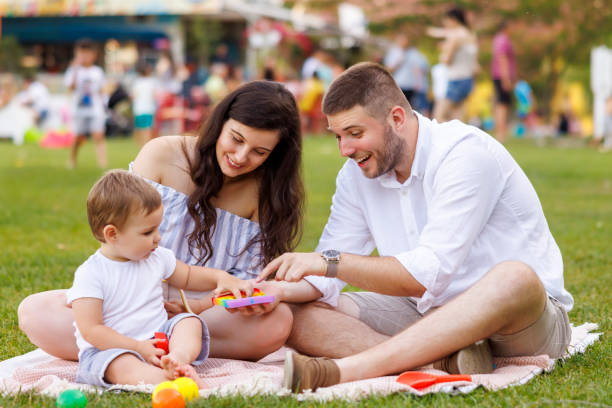 istock Young parents having fun on picnic with their child 1842317141