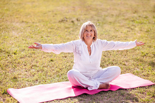 istock senior woman practicing yoga 184234154