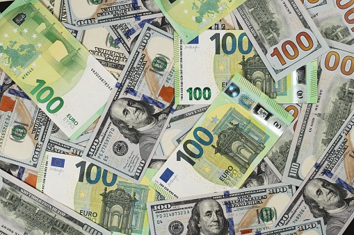 Hundred dollars and euros bills. Finance concept background.