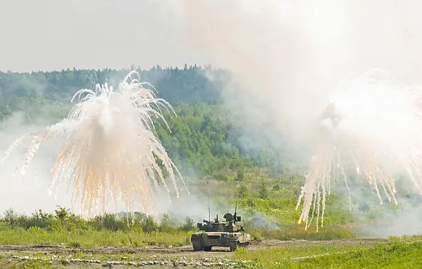 Russian tank T-80 making smoke screen from enemy
