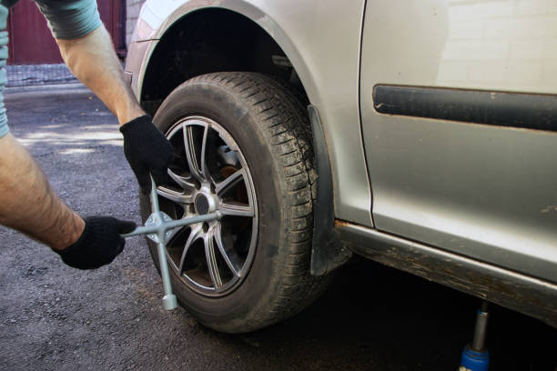 istock Car mechanic changing wheels in car 1842353044
