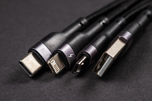 digital computer or smartphone cables. Usb type c, mini-usb, lightning connector. on dark background.