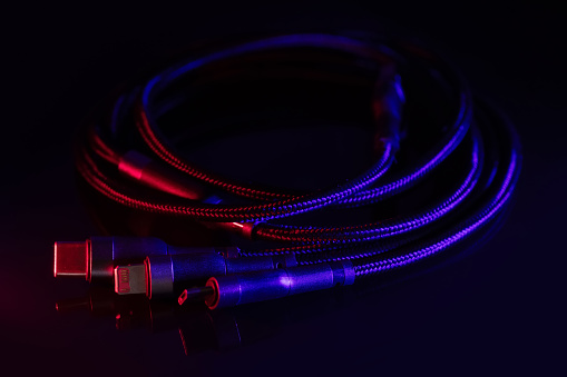 digital computer or smartphone cables. Usb type c, mini-usb, lightning connector. on dark background.