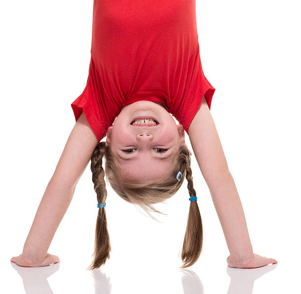 little girl standing on her hand