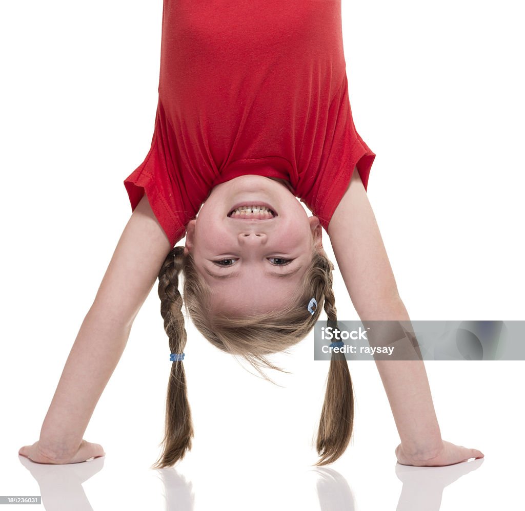 little girl standing on her hand little girl standing on her hand isolated on white Gymnastics Stock Photo