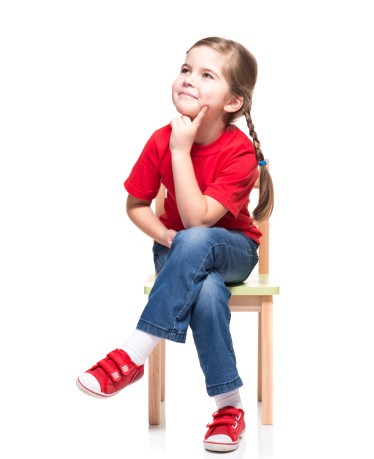 little girl wearing red t-short and posing on chair on white background