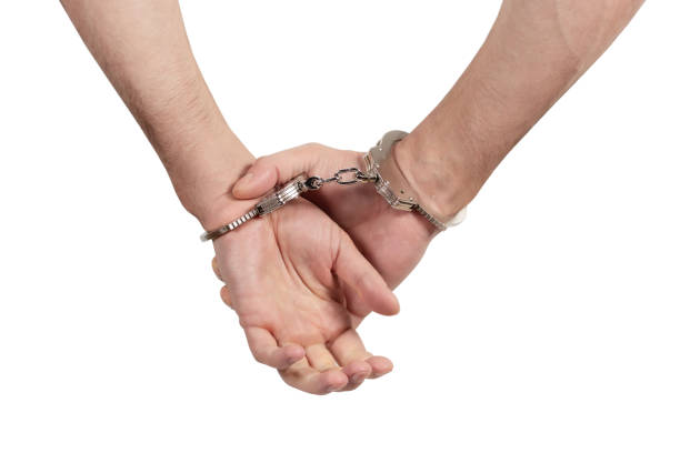 istock Man's hands in handcuffs on a white background, isolated 1842362934