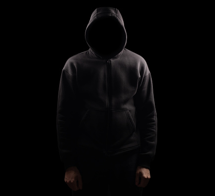 Silhouette of man in the hood or hooligan over dark background with copy space,