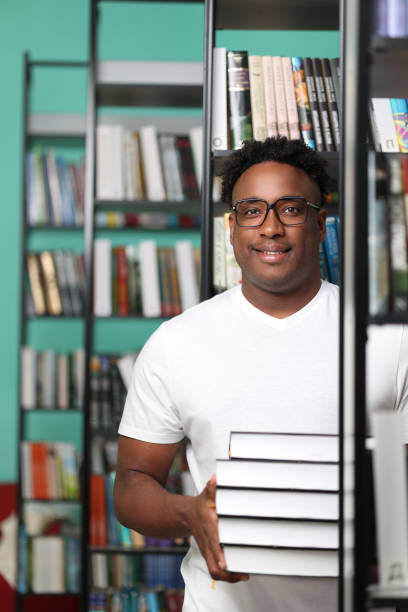 istock Young male journalist in library looking for interesting material for article 1842364019