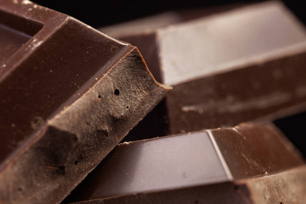 istock Broken chocolate. Chocolate pieces. Chocolate pieces on dark background. 1842365068
