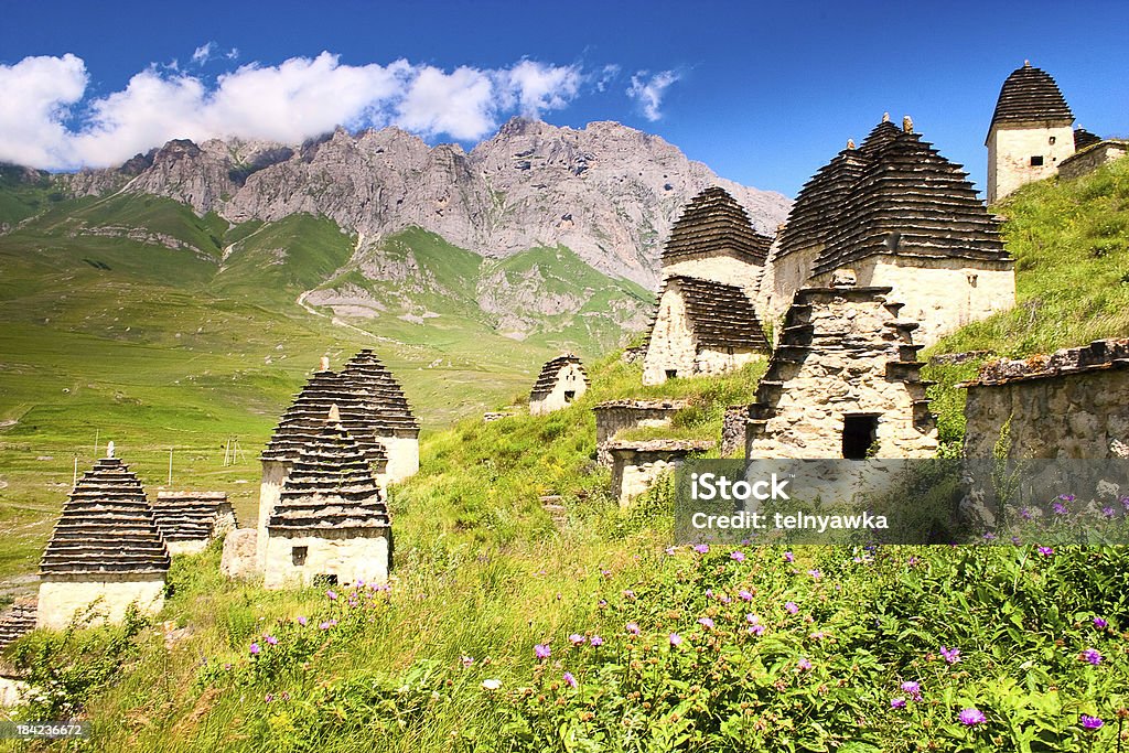 Ruins of ancient settlement in the Caucasus mountains Ruins of ancient settlement in the Caucasus mountains (tombs and sarcophagus) Agricultural Field Stock Photo