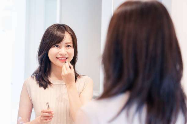 istock Young woman applying makeup at home 1842376552