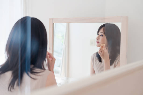 istock Young woman applying makeup at home 1842377061