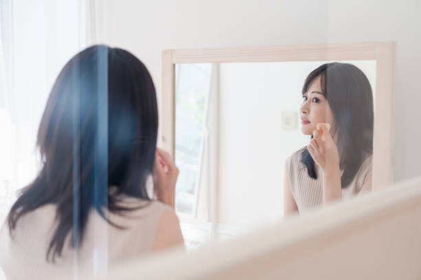 istock Young woman applying makeup at home 1842377062
