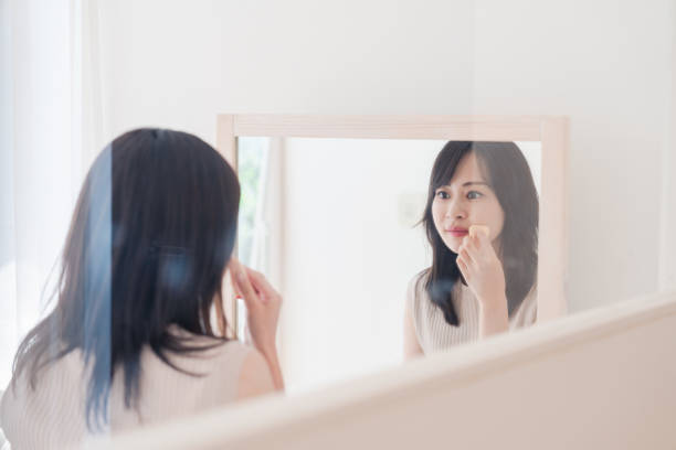 istock Young woman applying makeup at home 1842377065