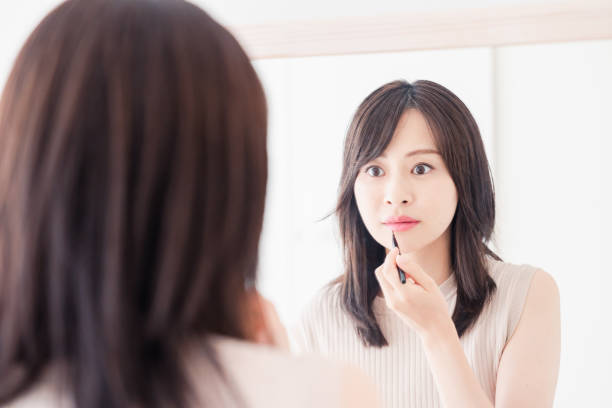 istock Young woman applying makeup at home 1842377605