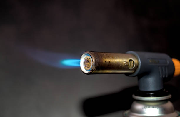 istock Blowtorch with flame on dark background 1842412460