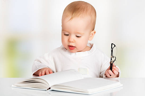 istock funny baby reading a book 184243118