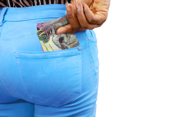 istock Black lady putting few Botswanan Pula notes into her back pocket. Removing money from pocket, hold money 1842442327