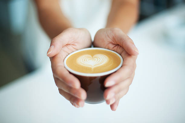 istock Female giving coffee with heart symbol 184250341