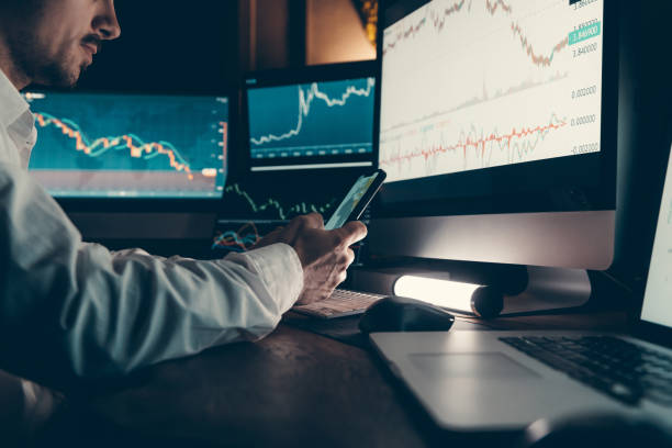 istock Confident male financial broker using technology and analyzing stock market data while working late in office 1842518997