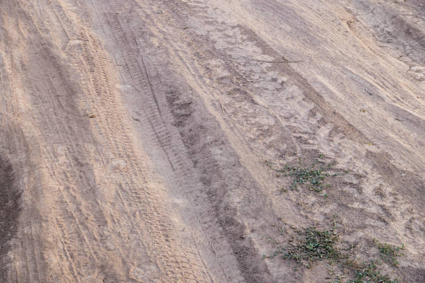 istock dusty dirt road at summer day, full-frame closeup view 1842550430