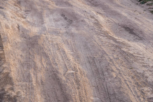 dusty dirt road at summer day, full-frame closeup view