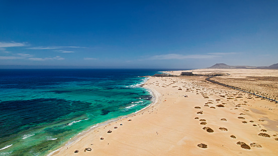 windsurfer on beautiful beach in Canary islands, windsurfing activity, aerial view of Sotavento coast in Fuerteventura