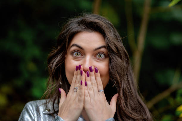 istock Stunned woman covers her mouth with her hands 1842572106