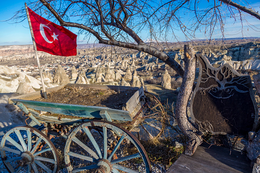 Turkish flag on a wagon and a rock desert.