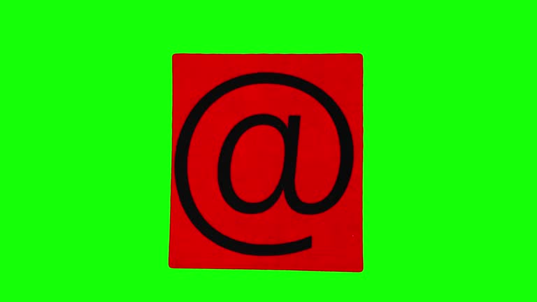 Email icon at sign on red piece of paper crumpling in stop motion against green screen