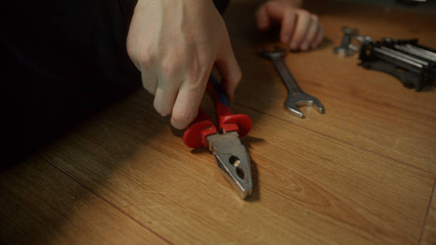 istock Expert Plumber Demonstrating Precise Pipe Work with Close-Up pliers 1842579548