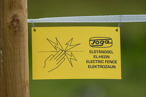 Gothenburg, Sweden - July 23 2023: Warning sign on an electric fence.
